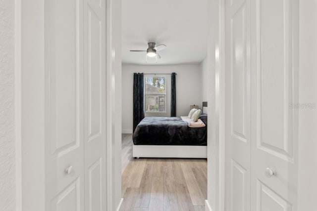 bedroom with ceiling fan and light hardwood / wood-style flooring