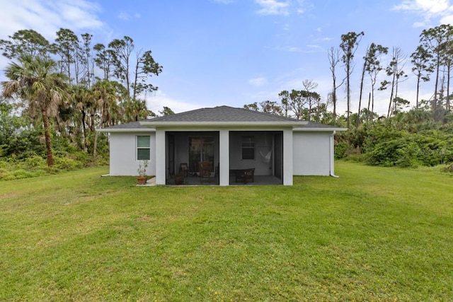 rear view of property with a yard