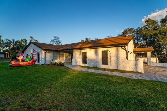 rear view of property featuring a yard