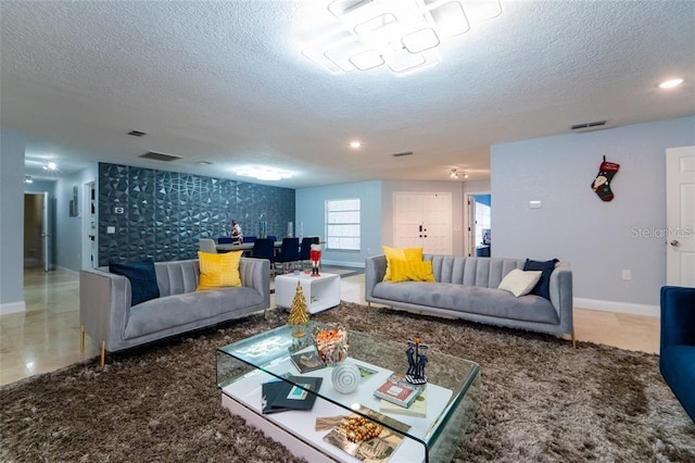 tiled living room featuring a textured ceiling