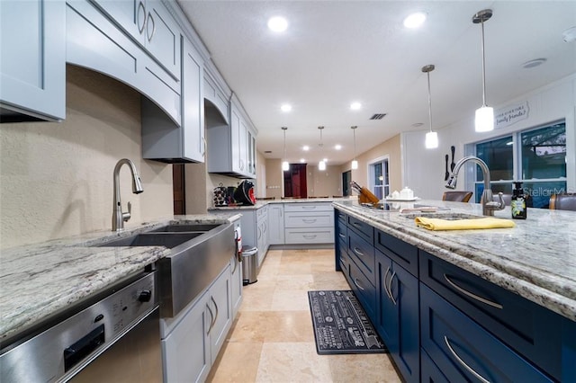 kitchen featuring light stone counters, white cabinets, pendant lighting, stainless steel dishwasher, and light tile patterned floors