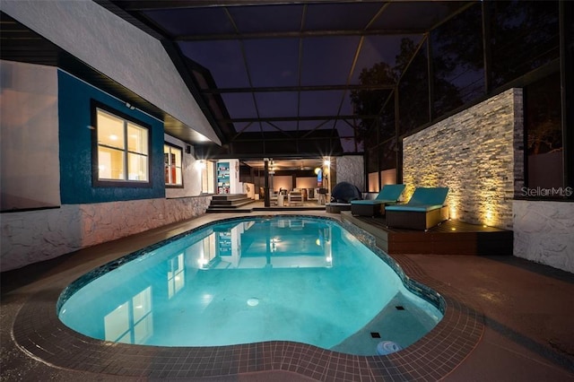 view of pool with an outdoor living space, a lanai, and a patio area