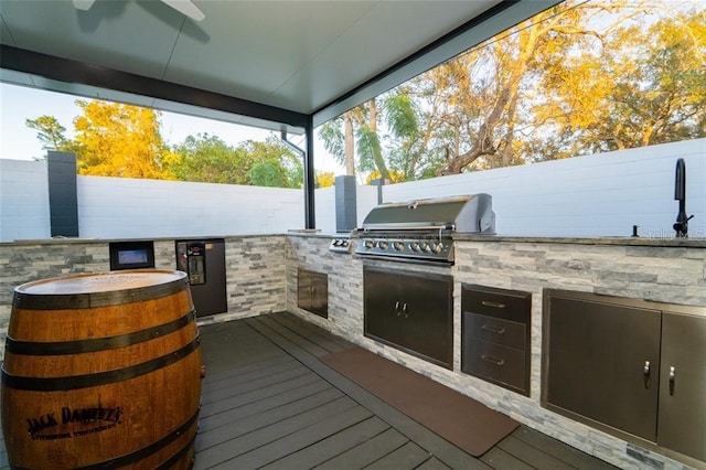 deck with grilling area and an outdoor kitchen