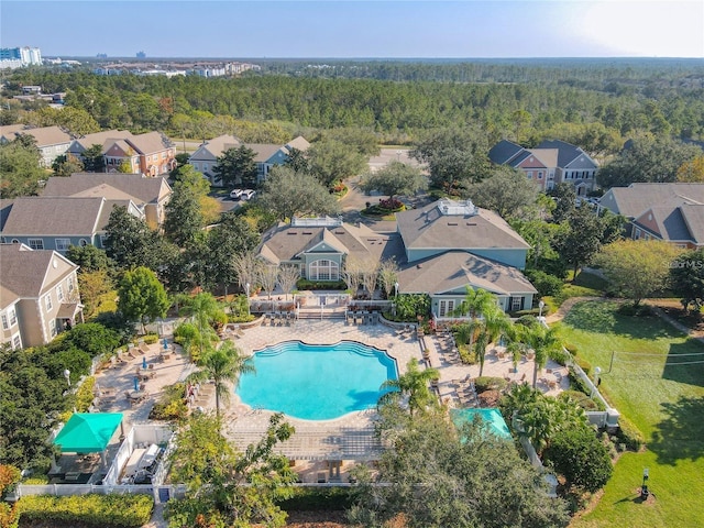 drone / aerial view with a residential view and a wooded view