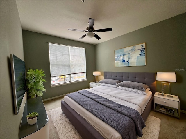 bedroom with ceiling fan and light colored carpet