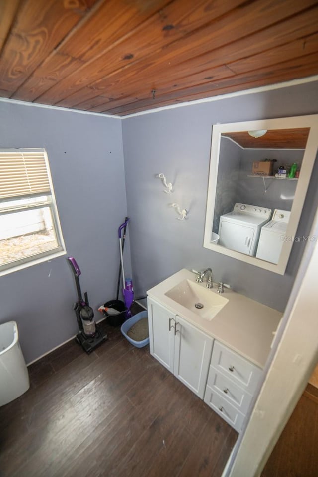 bathroom with wood-type flooring, vanity, wooden ceiling, and washing machine and clothes dryer