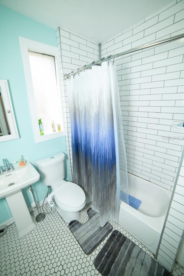 bathroom featuring tile patterned floors, shower / tub combo, and toilet