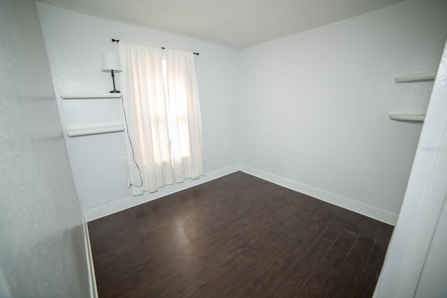 empty room with dark hardwood / wood-style floors