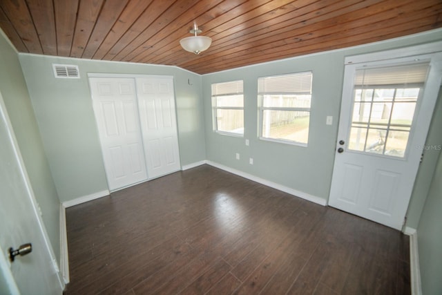 unfurnished bedroom featuring multiple windows, wood ceiling, dark wood-type flooring, and a closet