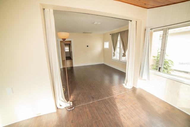 empty room featuring hardwood / wood-style floors and wooden ceiling