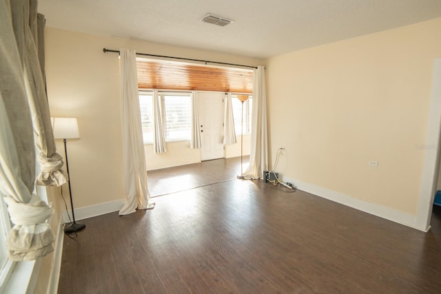 empty room with dark wood-type flooring