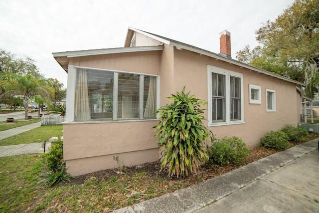 view of property exterior featuring a lawn