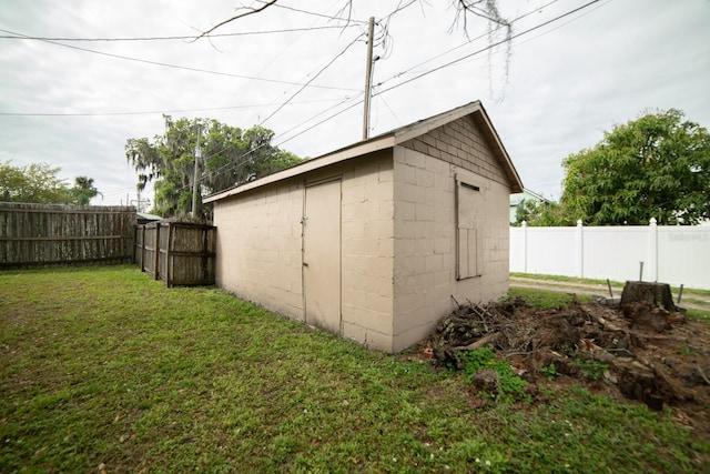 view of outbuilding featuring a lawn