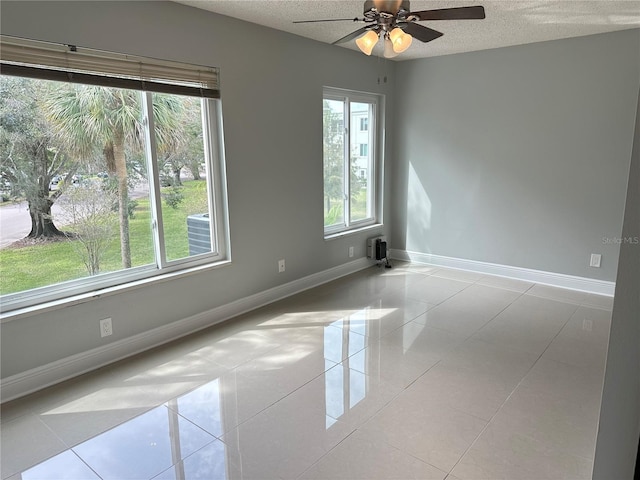 spare room featuring a wealth of natural light and light tile patterned floors