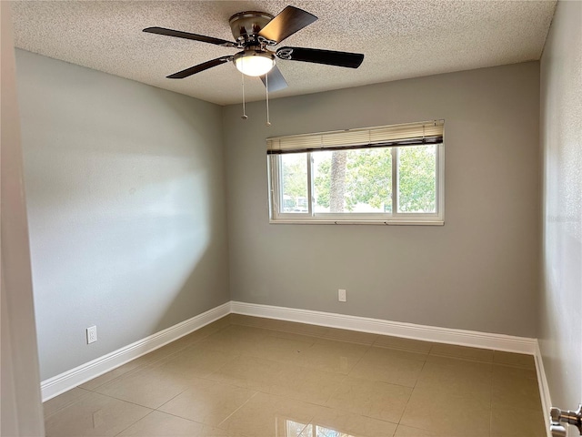 unfurnished room with light tile patterned flooring, a textured ceiling, and ceiling fan