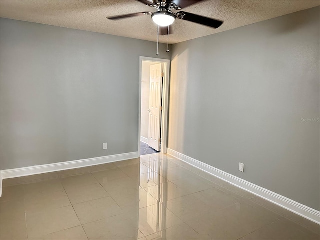 tiled spare room featuring ceiling fan and a textured ceiling