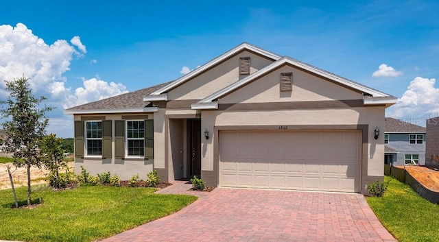 view of front of home featuring a garage and a front yard