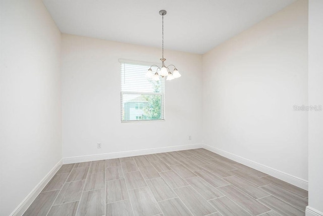 spare room featuring a chandelier