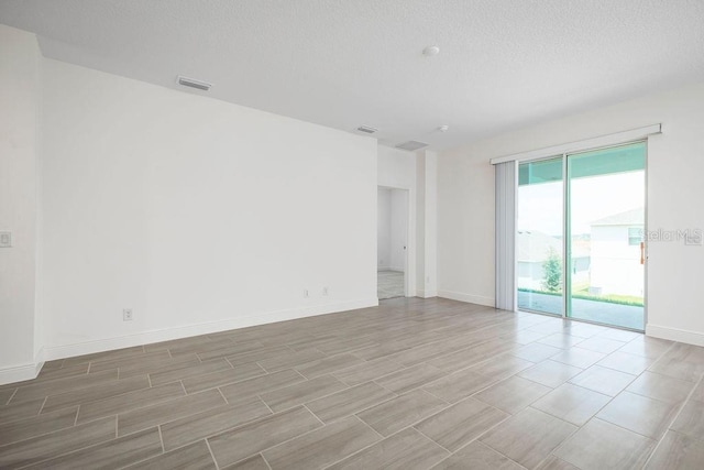 spare room with a textured ceiling