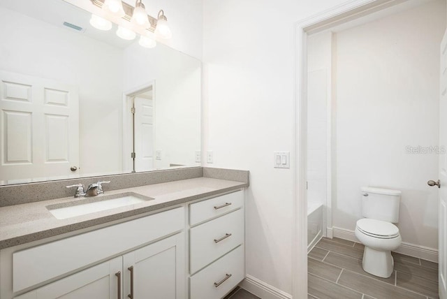 full bathroom featuring vanity, toilet, and  shower combination