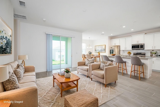 living room featuring light hardwood / wood-style flooring and sink