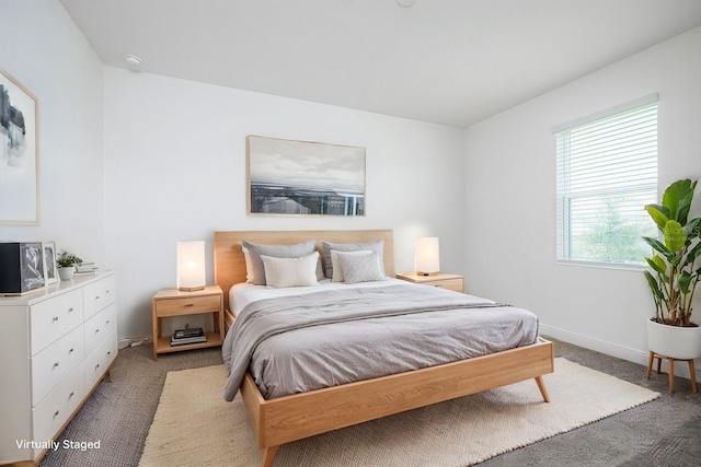 bedroom with dark colored carpet