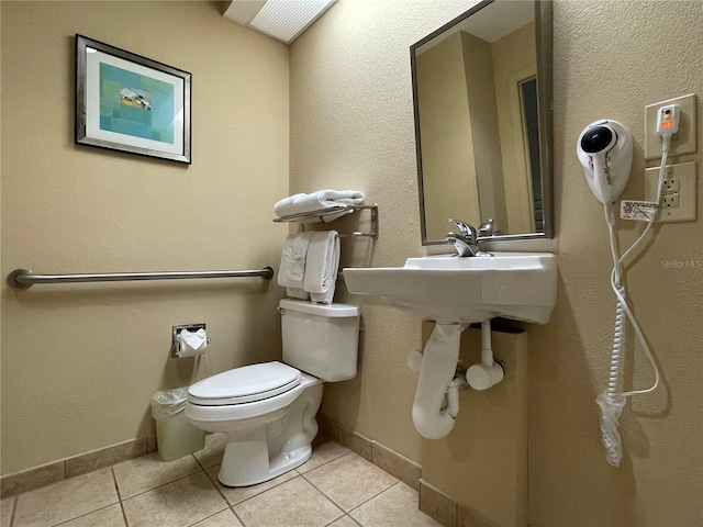 bathroom featuring toilet and tile floors