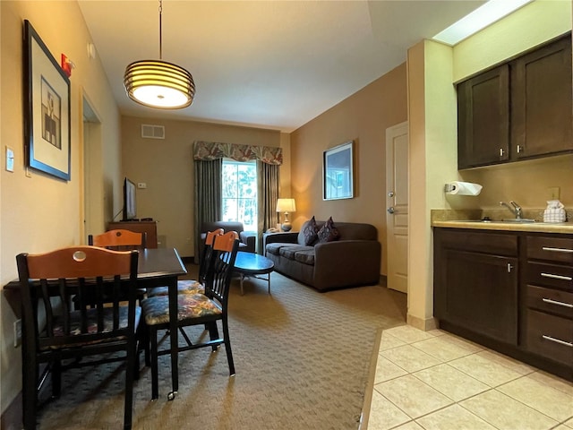 dining area with sink and light tile floors