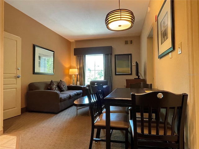 dining room featuring light carpet