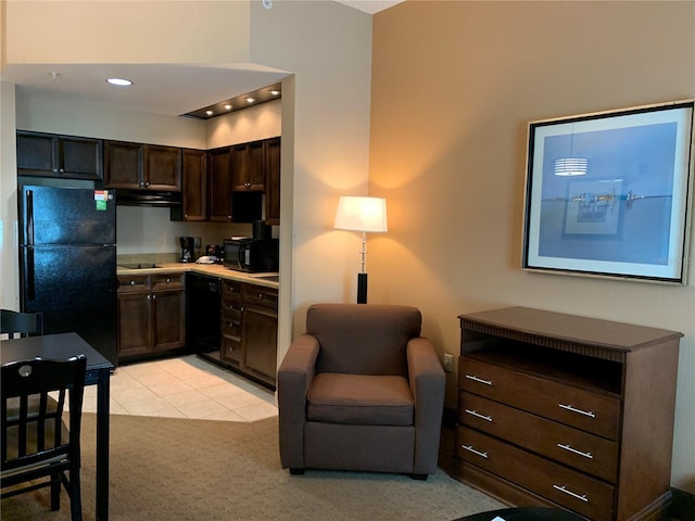 kitchen featuring black appliances, exhaust hood, light colored carpet, and dark brown cabinetry