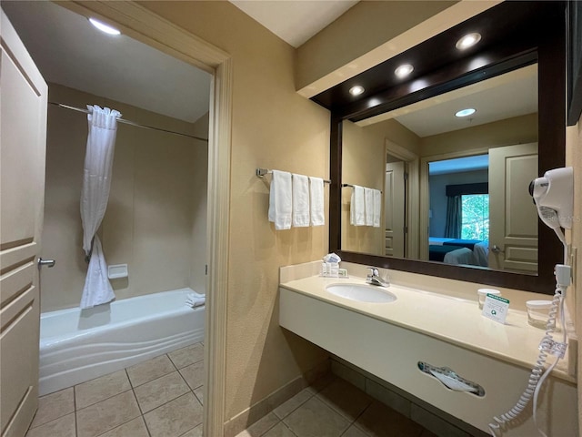 bathroom featuring tile patterned flooring, shower / bath combo with shower curtain, and vanity