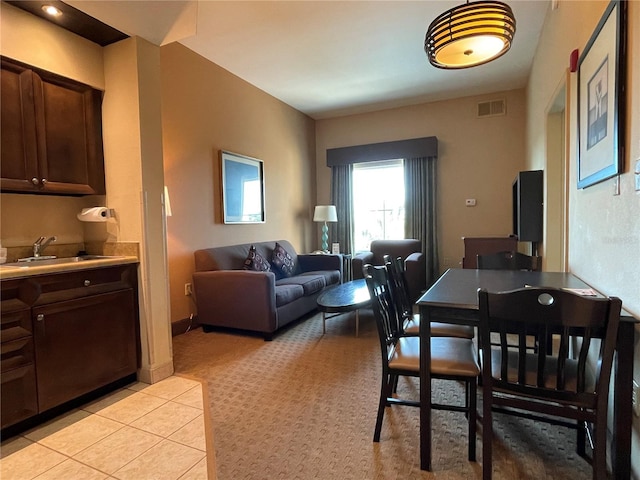 tiled dining area featuring sink