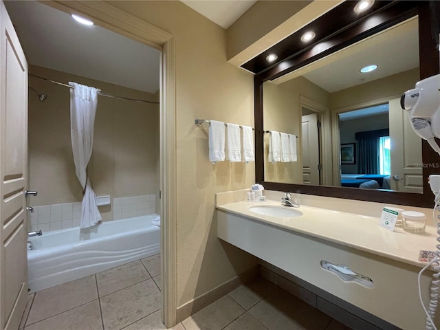 bathroom featuring a bath to relax in, tile floors, and large vanity