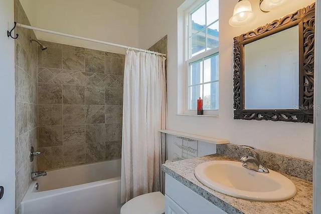 full bathroom featuring shower / bath combination with curtain, oversized vanity, toilet, and a wealth of natural light