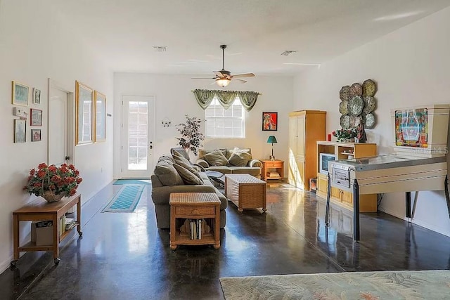 living room with ceiling fan and a wealth of natural light