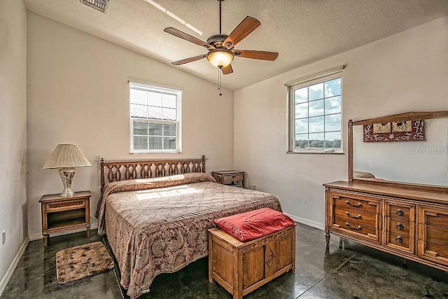 bedroom featuring lofted ceiling, a textured ceiling, and ceiling fan