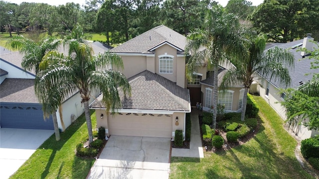 view of front of house featuring a garage and a front lawn