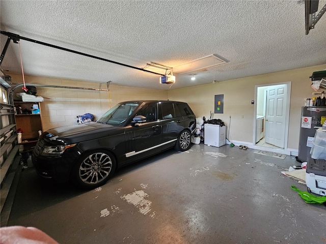 garage featuring electric panel, water heater, and a garage door opener