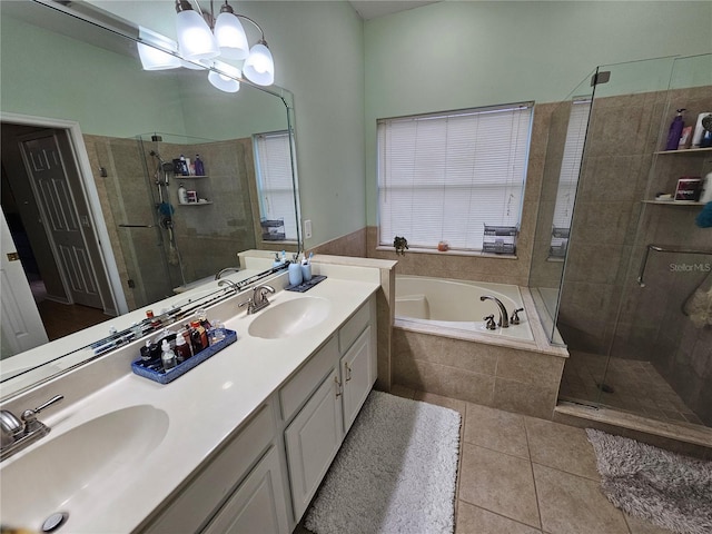 bathroom with tile patterned flooring, vanity, independent shower and bath, and a chandelier