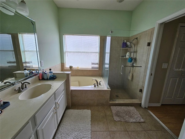 bathroom featuring tile patterned floors, plenty of natural light, separate shower and tub, and vanity