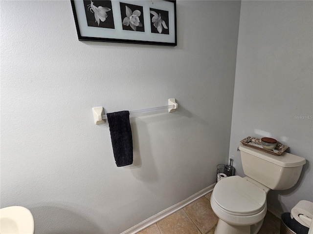 bathroom with tile patterned floors and toilet