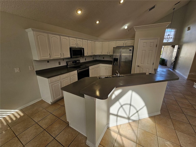 kitchen featuring stainless steel fridge, light tile patterned floors, white cabinetry, and black electric range oven