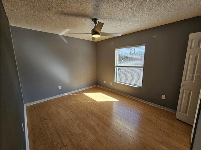 unfurnished room featuring a textured ceiling, light hardwood / wood-style floors, and ceiling fan