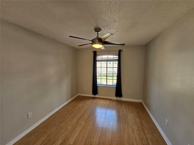 spare room with ceiling fan, light hardwood / wood-style flooring, and a textured ceiling