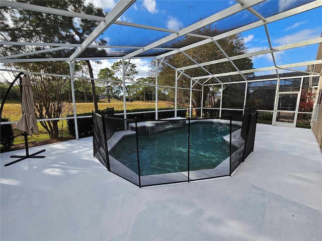 view of swimming pool with glass enclosure and a patio area