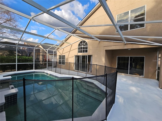 view of pool with a patio and glass enclosure