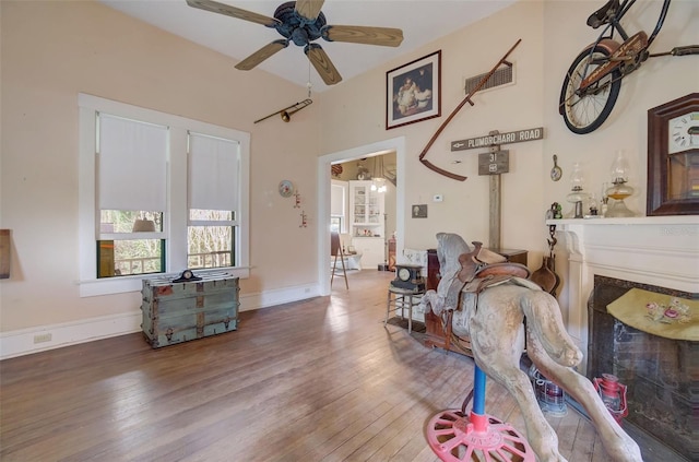 living room with wood-type flooring and ceiling fan