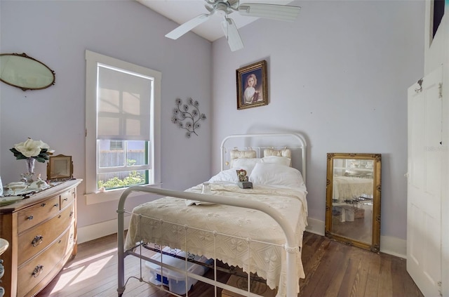 bedroom with ceiling fan and dark hardwood / wood-style floors