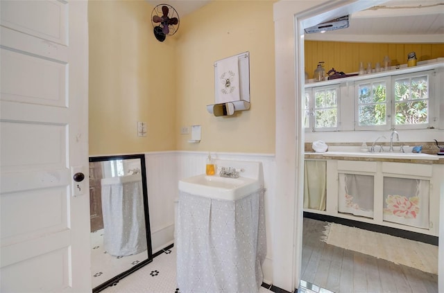 bathroom featuring hardwood / wood-style floors, lofted ceiling, and vanity