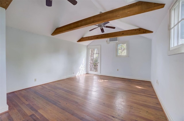 spare room featuring ceiling fan, lofted ceiling with beams, and wood-type flooring